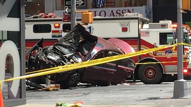 A smashed car sits on the corner of Broadway and 45th Street in New York's Times Square after driving through a crowd of pedestrians