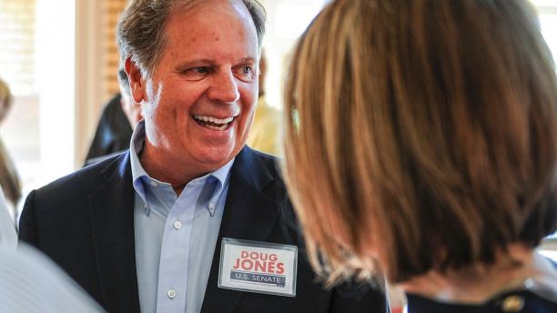 FILE - In this Aug. 3, 2017, file photo, candidate Doug Jones chats with constituents before a Democratic Senate candidate forum at the Princess Theatre in Decatur, Ala.   Jones is facing Michael Hansen , who leads an environmental group, in the Democrat primary on Tuesday, Aug. 15.  .  (Jeronimo Nisa /The Decatur Daily via AP, File)