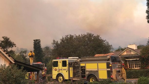 In this photo provided by the Santa Barbara County Fire Department,fire engines provide structure protection at the historic San Ysidro Ranch in Montecito, Calif., Saturday, Dec. 16, 2017. Santa Barbara County has issued new evacuation orders as a huge wildfire bears down on Montecito and other communities. The Office of Emergency Services announced the orders Saturday as Santa Ana winds pushed the fire close to the community.  Mike Eliason/Santa Barbara County Fire Department via AP)