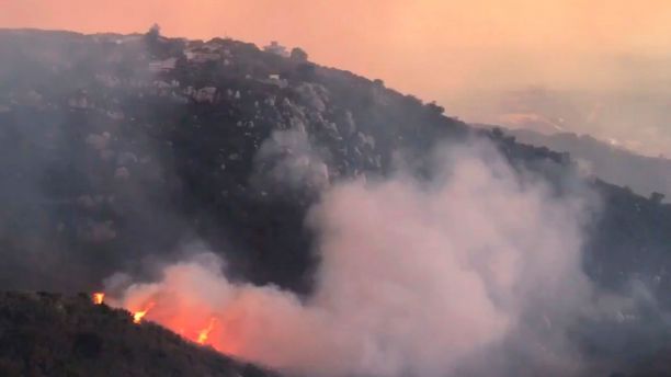 In this image taken from video provided by the Santa Barbara County Fire Department, a wind driven spot fire burns on the west side below Gibraltar Road as smoke from a wildfire fills the air in Santa Barbara, Calif., Saturday, Dec. 16, 2017. The Thomas Fire is now the third-largest in California history. (Mike Eliason/Santa Barbara County Fire Department via AP)