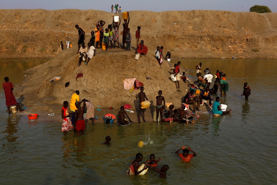 SOUTH SUDAN WAR displaced people wash and collect water