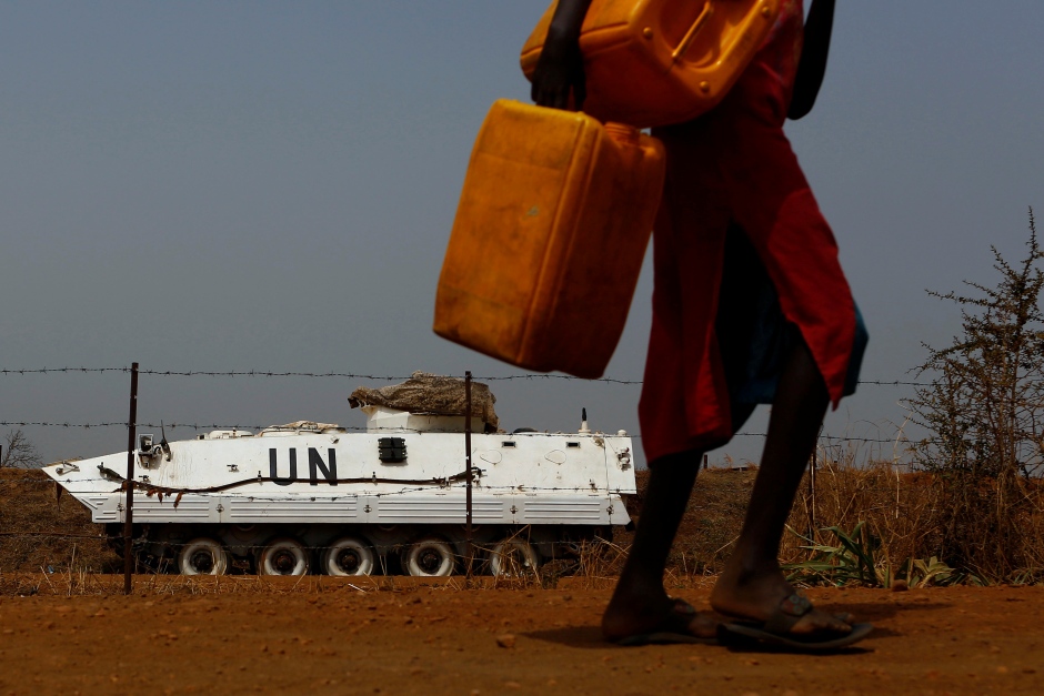 SOUTH SUDAN WAR displaced woman carries empty jerrycans