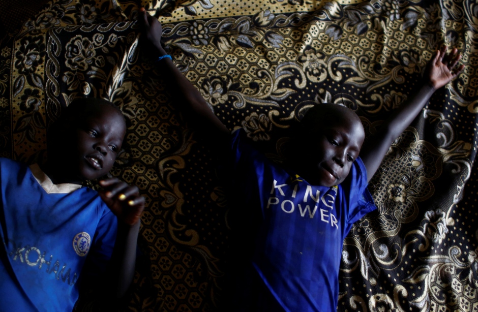 SOUTH SUDAN WAR CHILDREN rest on a bed