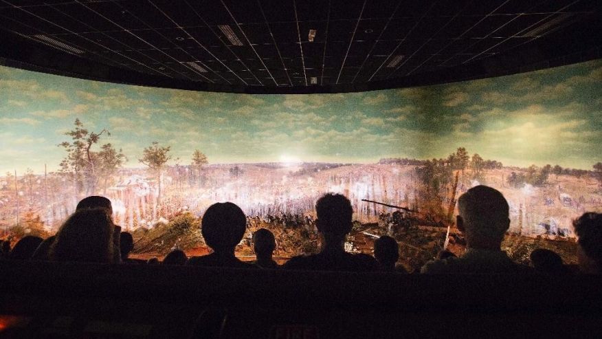 FILE - In this Tuesday, June 30, 2015, file photo, visitors view the Atlanta Cyclorama, the colossal Civil War painting in Atlanta. The painting depicting the Battle of Atlanta from the American Civil War will soon be moved from the building where it has been displayed for nearly a century. Historians said moving the 6-ton Cyclorama, one of the nation's largest paintings, from Grant Park to the Atlanta History Center across town marks a major milestone in its restoration. The move is to begin Thursday, Feb. 9, 2017. (AP Photo/David Goldman, File)