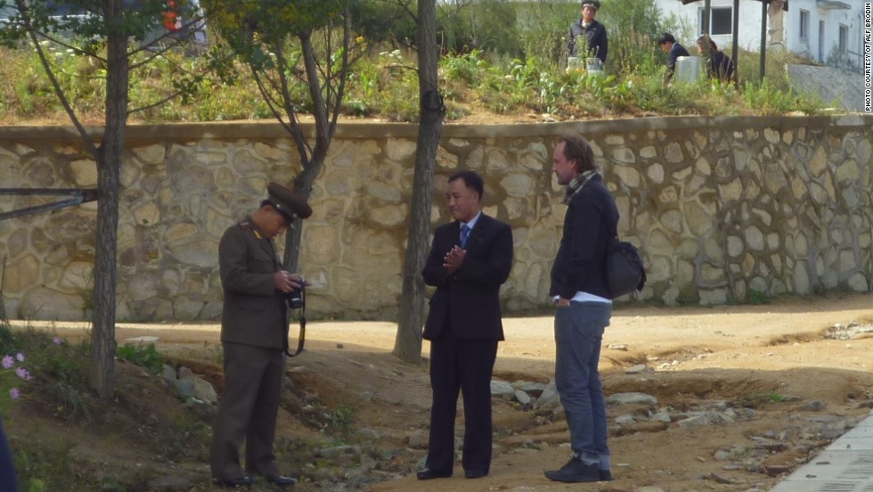 Writer Johan Nylander and his guide, Ko Chang Ho, watch as a North Korean guard deletes 90 photos deemed unacceptable. Nylander was able to recover the photos with the help of an IT specialist -- the images that follow are an edited selection.