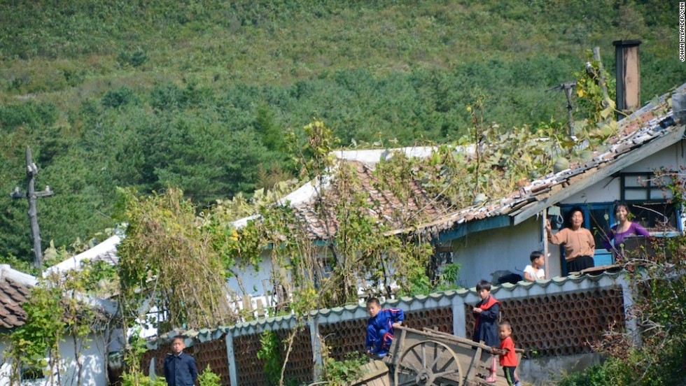 Kids playing outside village houses.