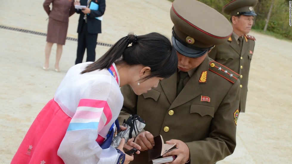 Custom official and tourist bureau guide checking foreigners' passports.