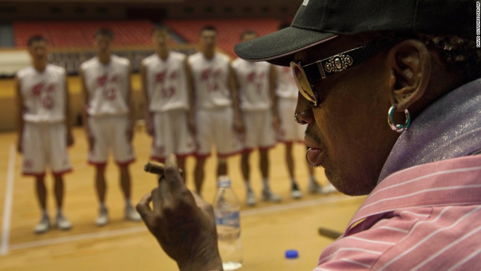 Rodman holds a cigar as he speaks to North Korean basketball players during a practice session in Pyongyang on December 20.
