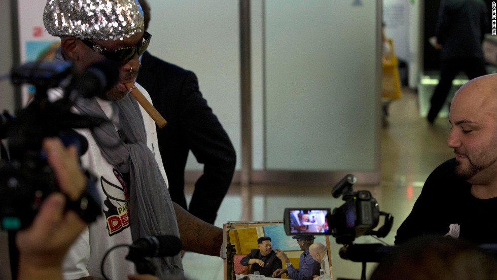 Rodman shows photos of himself with North Korean leader Kim Jong Un while talking to journalists at the Beijing airport on September 7 after his second trip to the reclusive, nuclear-armed nation. Rodman returned from the communist country announcing he will put together a "basketball diplomacy" event with players from North Korea. But he put a damper on any speculation he might have been trying to free imprisoned American Kenneth Bae.