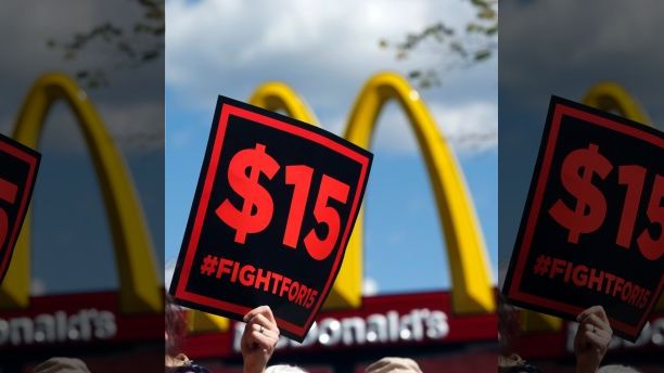 FILE - In this July 22, 2015 file photo, supporters of a $15 minimum wage for fast food workers rally in front of a McDonald's in Albany, N.Y. Millions of workers across the U.S. will see their pay increase as 19 states bump up their minimum wages as the new year begins. California, New York and Arizona are among the states with increases taking effect Saturday, Dec. 31, 2016 or Sunday, Jan. 1, 2017. New York state is taking a regional approach, with the wage rising to $11 in New York City, $10 in its suburbs and $9.70 upstate. (AP Photo/Mike Groll, File)
