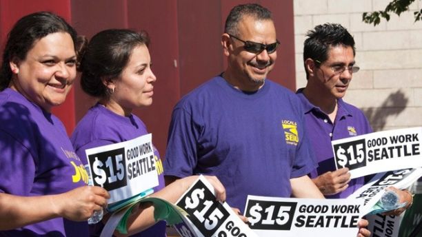 Labor activists celebrate during a rally at Seattle City Hall after a Seattle City Council meeting in which the council voted on raising the minimum wage to $15.00 per hour in Seattle, Washington June 2, 2014. The Seattle city council voted unanimously on Monday to approve a sharp increase in the city's minimum wage to $15 an hour over the next seven years, marking the first time a major U.S. city has committed to such a high base level of pay.  REUTERS/David Ryder   (UNITED STATES - Tags: BUSINESS EMPLOYMENT) - RTR3RX17