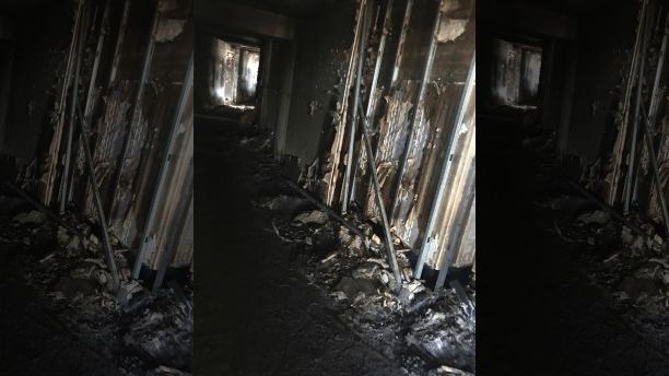 This photo provided by Bruce Campbell, a unit manager in the Marco Polo building in Honolulu, shows the charred interior of the building on Saturday, July 15, 2017. A fire broke out Friday afternoon in a unit on the 26th floor, where all three of the dead were found, Fire Chief Manuel Neves said. The building is not required to have fire sprinklers, which would have confined the blaze to the unit where it started, Neves said. The 36-floor building near the tourist mecca of Waikiki was built in 1971, before sprinklers were mandatory in high-rises. (Bruce Campbell via AP)