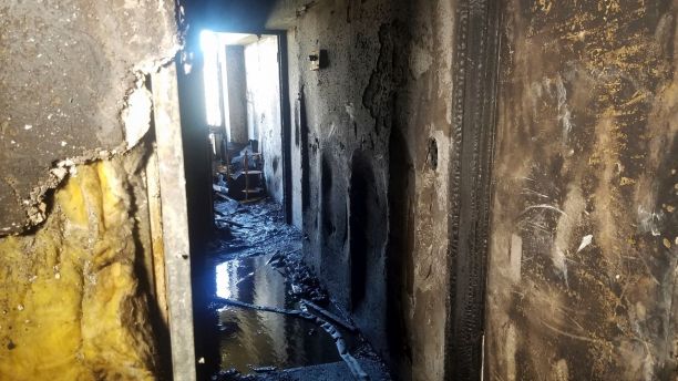 In this photo provided by KITV, fire damage from a blaze that killed three people and left 12 injured in the Marco Polo building in Honolulu is shown on Saturday, July 15, 2017. The fire broke out Friday afternoon in a unit on the 26th floor, where all three of the dead were found, Fire Chief Manuel Neves said. The building is not required to have fire sprinklers, which would have confined the blaze to the unit where it started, Neves said. The 36-floor building near the tourist mecca of Waikiki was built in 1971, before sprinklers were mandatory in high-rises. (Brenton Awa/KITV via AP)