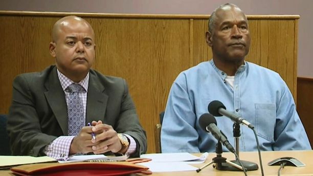 Former NFL football star O.J. Simpson appears with his attorney, Malcolm LaVergne, left, via video for his parole hearing at the Lovelock Correctional Center in Lovelock, Nev., on Thursday, July 20, 2017.  Simpson was convicted in 2008 of enlisting some men he barely knew, including two who had guns, to retrieve from two sports collectibles sellers some items that Simpson said were stolen from him a decade earlier. (Lovelock Correctional Center via AP)
