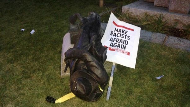 A toppled Confederate statue lies on the ground on Monday, Aug. 14, 2017, in Durham, N.C. Activists on Monday evening used a rope to pull down the monument outside a Durham courthouse. The Durham protest was in response to a white nationalist rally held in Charlottesville, Va, over the weekend. Authorities say one woman was killed Saturday after one of the white nationalists drove his car into a group of counterprotesters. (AP Photo/Jonathan Drew)