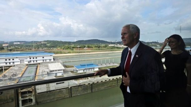 U.S. Vice President Mike Pence, photographed through a window, looks out over the Cocoli Locks during his visit to the Panama Canal in Panama City, Thursday, Aug. 17, 2017. Panama is Pence's last stop during his week-long tour of Latin America. (AP Photo/Arnulfo Franco)