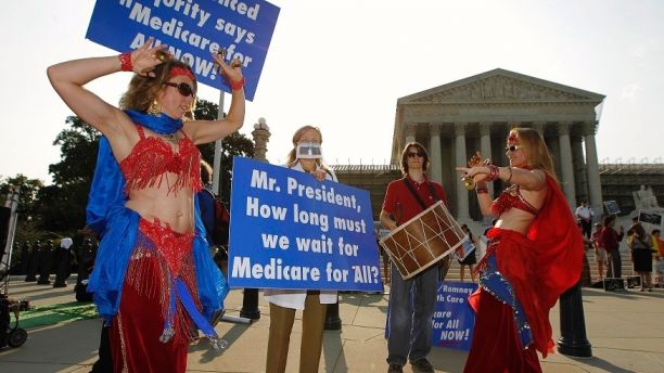 Belly dancers calling for single payer national health insurance perform outside the Supreme Court in Washington, June 28, 2012. The Supreme Court is set to deliver on Thursday its ruling on President Barack Obama's 2010 healthcare overhaul, his signature domestic policy achievement, in a historic case that could hand him a huge triumph or a stinging rebuke just over four months before he seeks re-election. REUTERS/Jason Reed (UNITED STATES - Tags: POLITICS HEALTH) - RTR34A4N