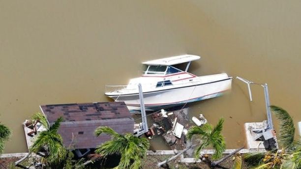 A boat is partially submerged in a canal in the wake of Hurricane Irma, Monday, Sept. 11, 2017, in Key Largo, Fla. (AP Photo/Wilfredo Lee)