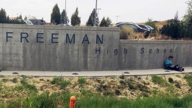 The sign for Freeman High School in Rockford, Wash., is seen outside the campus Wednesday, Sept. 13, 2017. Authorities say one student was killed and three others were injured in a shooting at the school. A suspect was taken into custody. (AP Photo/Nicholas K. Geranios).