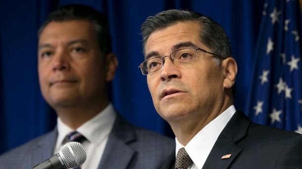 FILE - In this Sept. 5, 2017 file photo, California Attorney General Xavier Becerra, right, flanked by Secretary of State Alex Padilla, speaks to reporters at the Capitol in Sacramento. Becerra filed a lawsuit Monday, Sept. 11, against the Trump administration over its decision to end the Deferred Action for Childhood Arrivals program, or DACA, that protects young immigrants from deportation who were brought to the U.S. illegally as children or by parents who overstayed visas. (AP Photo/Rich Pedroncelli, File)