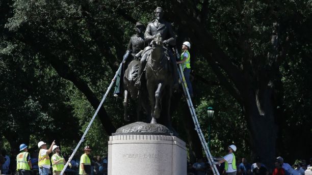 Workers inspect a statue of Robert E. Lee in a public park in Dallas, Wednesday, Sept. 6, 2017. The Dallas City Council voted to removed the statue however a last minute court injunction halted the work. (AP Photo/LM Otero)