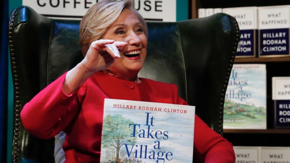 Hillary Clinton holds a copy of her book,