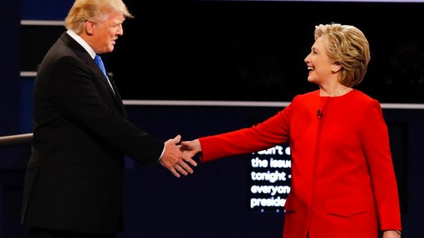 FILE - In this Sept. 26, 2016 file photo, Republican presidential nominee Donald Trump and Democratic presidential nominee Hillary Clinton shake hands during the presidential debate at Hofstra University in Hempstead, N.Y. Months after her defeat in the election some have speculated she might run for elected office again, a possibility she hasn't flat-out denied, but has said she doesn't expect to happen. Friends say it's unlikely. (AP Photo/David Goldman, File)