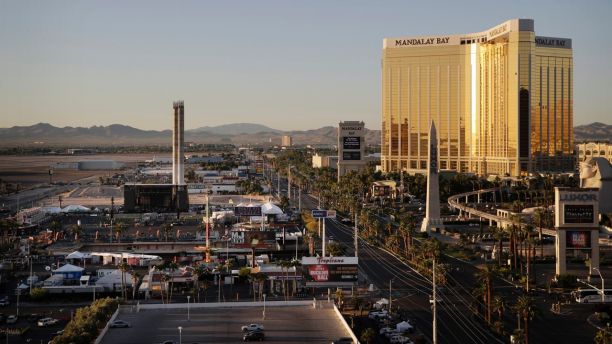 The Mandalay Bay resort and casino, right, overlooks an outdoor festival grounds across the street, left, Tuesday, Oct. 3, 2017, in Las Vegas. Authorities said Stephen Craig Paddock broke the windows on the casino and began firing with a cache of weapons, killing dozens and injuring hundreds at a music festival at the grounds. (AP Photo/John Locher)