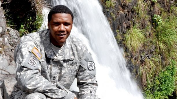 In this June 6, 2015 photo, U.S. Army National Guard Sgt. 1st Class Charleston Hartfield of the 100th Quartermaster Company poses for a photo at Rainbow Falls near Hilo, Hawaii. Hartfield was one of the people killed in Las Vegas after a gunman opened fire on Sunday, Oct. 1, 2017, at a country music festival. (Sgt. Walter Lowell/U.S. Army National Guard via AP)