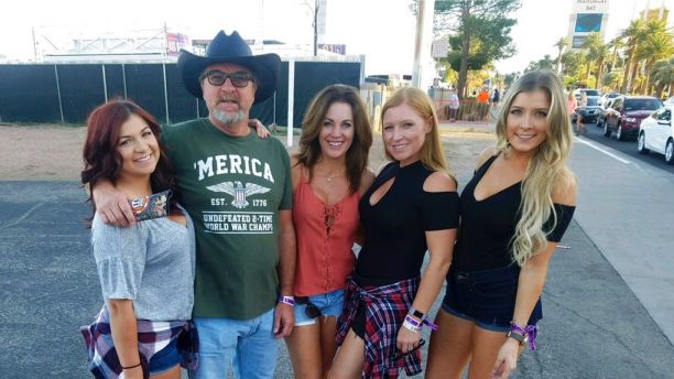 This Sunday, Oct. 1, 2017, photo provided by Tom Day Sr., shows his son Tom Day Jr, with Day Jr.'s family, at the Route 91 Harvest Festival in Las Vegas. Day Jr., was one of the people killed in Las Vegas after a gunman opened fire on Sunday, Oct. 1, 2017, at the music festival. (Courtesy of Tom Day Jr. via AP)