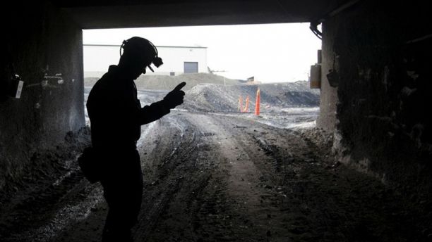 FILE - In this Nov. 9, 2010 file photo, a mine employee stands in the entry of the Signal Peak Energy's Bull Mountain mine in Roundup, Montana. Signal Peak is asking a federal appellate court to intervene after a judge halted a planned expansion. The company says the decision could shut down work and trigger layoffs. (AP Photo/Janie Osborne, File)