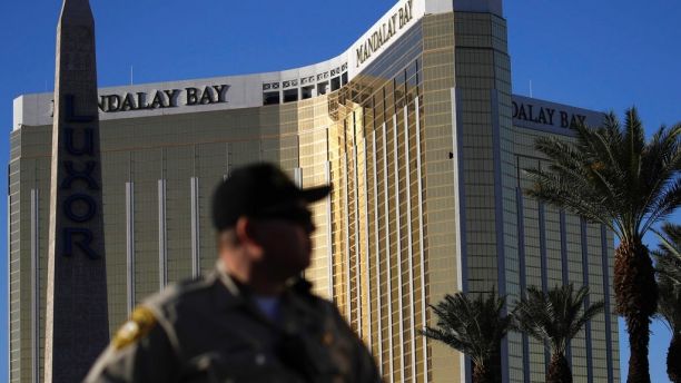 FILE - In this Tuesday, Oct. 3, 2017 file photo, a Las Vegas police officer stands by a blocked off area near the Mandalay Bay casino in Las Vegas. On Sunday, Oct. 1, Stephen Paddock opened fire on the Route 91 Harvest Festival killing dozens and wounding hundreds.  Paddock spent hours in casinos. and was known for betting big on video poker and staring down fellow gamblers.  There is no indication, though, that any particular grievance set him off. But details that have surfaced so far about the one-time IRS agent and son of a notorious bank robber, are clues, at least, to his mindset.  (AP Photo/John Locher, File)