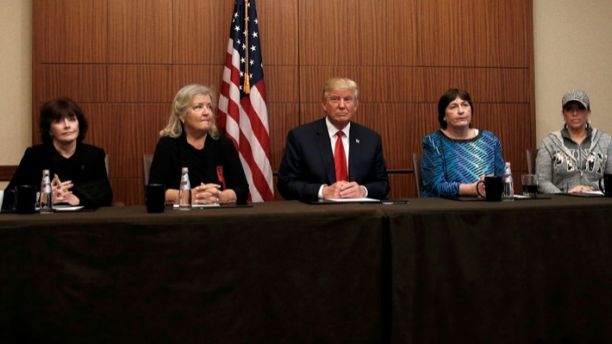Republican presidential nominee Donald Trump sits with (from R-L) Paula Jones, Kathy Shelton, Juanita Broaddrick and Kathleen Willey in a hotel conference room in St. Louis, Missouri, U.S., shortly before the second presidential debate at Washington University in St. Louis, October 9, 2016. REUTERS/Mike Segar - S1BEUGBLXIAA