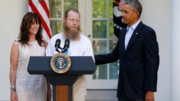 U.S. President Barack Obama (R) watches as Jami Bergdahl (L) and Bob Bergdahl talk about the release of their son, prisoner of war U.S. Army Sergeant Bowe Bergdahl, during a statement in the Rose Garden at the White House in Washington May 31, 2014. Obama, flanked by the parents of Army Sergeant Bowe Bergdahl, a U.S. soldier who is being released after being held for nearly five years by the Taliban, said in the White House Rose Garden on Saturday that the United States has an