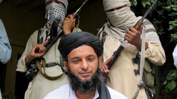 In this Thursday Aug. 15, 2013 photo, Asmatullah Muawiya, head of the Talibans faction of fighters from central Punjab province, listens to reporters at an undisclosed place in Pakistani tribal region of Waziristan. A senior Pakistani Taliban commander welcomed the governments recent offer to hold peace talks Thursday, raising the possibility the militant group has changed its stance after shunning negotiations earlier this year. (AP Photo/Ishtiaq Mahsud)
