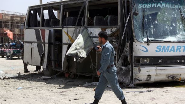 May 4, 2015 - An Afghan security man inspects the site of a suicide attack in Kabul, Afghanistan. An Afghan official says a suicide bomber struck a minibus carrying government employees in Kabul, killing at least one person and wounding more than a dozen.