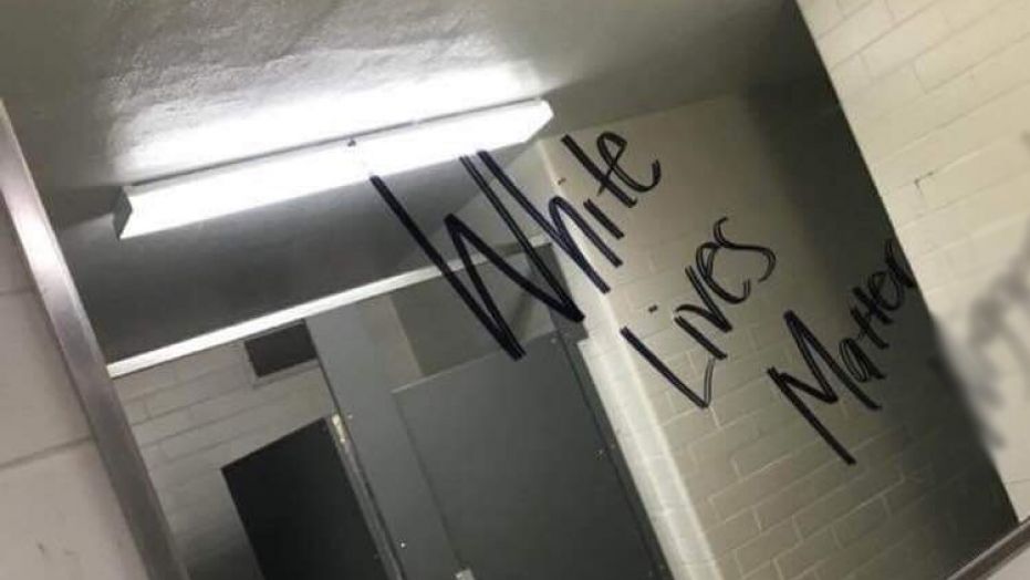Graffiti containing a racial slur (blurred) and phrase