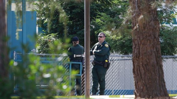 Law enforcement officers are seen at an elementary school in the community of Rancho Tehama Reserve, where a gunman opened fire Tuesday, Nov. 14, 2017, in Corning, Calif. A gunman choosing targets at random opened fire in the rural Northern California town Tuesday, killing several people at several sites and wounding others at the elementary school before police shot him dead, authorities said. (AP Photo/Rich Pedroncelli)