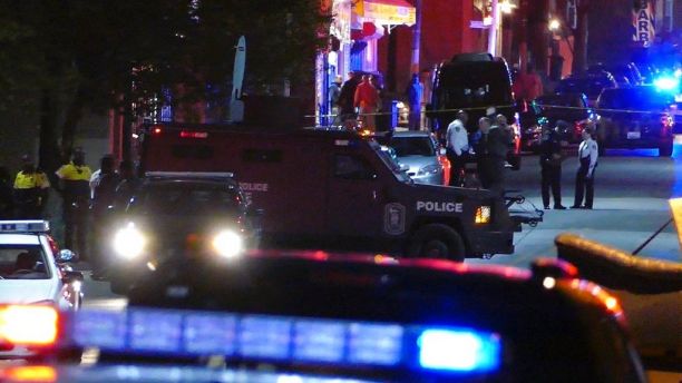 Police officers respond to Bennett Place and N. Fremont Avenue after a call went out that an officer is shot Wednesday, Nov. 15, 2017, in Baltimore, M.D.  Baltimore police said in a tweet that one of their officers was shot Wednesday evening. The department did not immediately disclose the officer's name or any other details. (Kevin Richardson/The Baltimore Sun via AP)