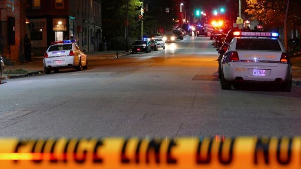 Police officers respond to Bennett Place and N. Fremont Avenue after a call went out that an officer is shot Wednesday, Nov. 15, 2017, in Baltimore, M.D. Baltimore police said in a tweet that one of their officers was shot Wednesday evening. The department did not immediately disclose the officer's name or any other details. (Kevin Richardson/The Baltimore Sun via AP)