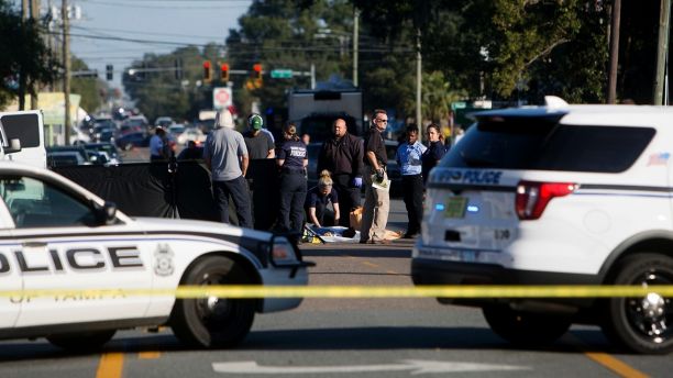 Law enforcement agents investigate a fatal shooting in the Seminole Heights neighborhood in Tampa, Fla., Tuesday, Nov. 14, 2017. Police searched the neighborhood after a person was shot dead, possibly by a serial killer. Spokesman Steve Hegarty said detectives can't immediately say whether the shooting is related to last month's 10-day spree where three people were slain, but officers are treating it like it is. (Jones, Octavio/Tampa Bay Times via AP)