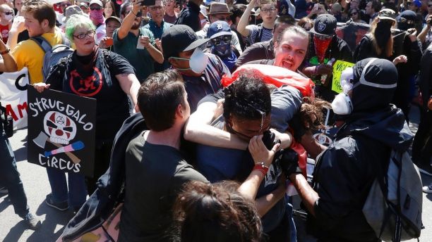 Demonstrators clash during a free speech rally Sunday, Aug. 27, 2017, in Berkeley, Calif. Several thousand people converged in Berkeley Sunday for a 