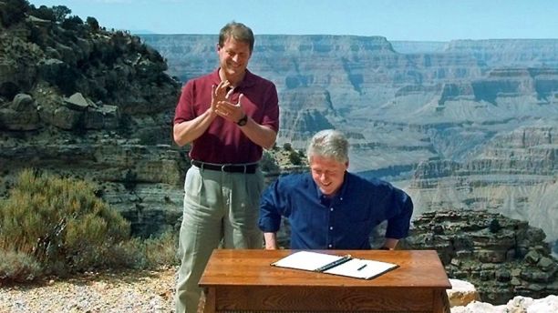 FILE - In this Sept. 18, 1996, file photo, Vice President Al Gore applauds after President Bill Clinton signs a bill designating about 1.7 million acres of land in southern Utah's red-rock cliff as the Grand Staircase-Escalante National Monument, at the Grand Canyon National Park, in Arizona. President Donald Trump is expected Monday, Dec. 4, 2017, to announce plans to shrink Bears Ears National Monument as well as Grand Staircase-Escalante National Monument in Utah that were created by past Democratic presidents. (AP Photo/Doug Mills, File)
