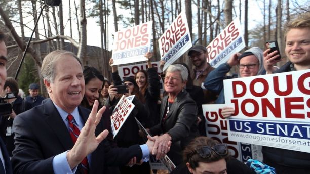 Democratic candidate Doug Jones greets supporters after casting his ballot Tuesday, Dec. 12, 2017, in Mountain Brook , Ala.   Jones is facing Republican Roy Moore. (AP Photo/John Bazemore)