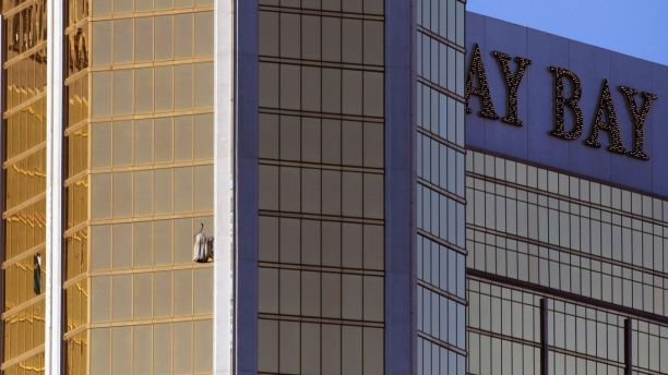 Drapes billow out of a broken window at the Mandalay Bay resort and casino Monday, Oct. 2, 2017, on the Las Vegas Strip following a deadly shooting at a music festival in Las Vegas. A gunman was found dead inside a hotel room.
