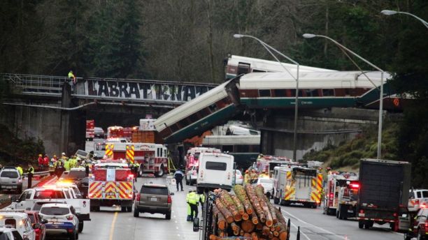 A derailed train is seen on southbound Interstate 5 on Monday, Dec. 18, 2017, in DuPont, Wash. An Amtrak train making an inaugural run on a new route derailed south of Seattle on Monday, spilling train cars onto a busy interstate in an accident that resulted in 