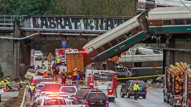 Cars from an Amtrak train that derailed lie spilled onto Interstate 5, Monday, Dec. 18, 2017, in DuPont, Wash. The Amtrak train making the first-ever run along a faster new route hurtled off the overpass Monday near Tacoma and spilled some of its cars onto the highway below, killing several people, authorities said. (Peter Haley/The News Tribune via AP)