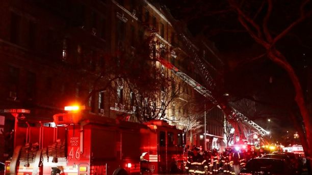 Firefighters respond to a building fire Thursday, Dec. 28, 2017, in the Bronx borough of New York. The Fire Department of New York says a blaze raging in a Bronx apartment building has seriously injured more than a dozen of people. (AP Photo/Frank Franklin II)