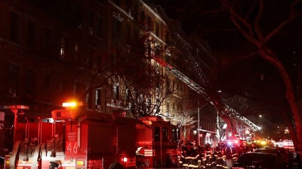 Firefighters respond to a building fire Thursday, Dec. 28, 2017, in the Bronx borough of New York. The Fire Department of New York says a blaze raging in a Bronx apartment building has seriously injured more than a dozen of people. (AP Photo/Frank Franklin II)