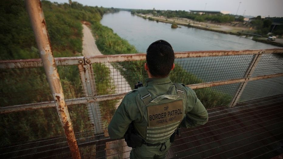 A U.S. border patrol agent looks over the Rio Grande river at the border between United States and Mexico, in Roma, Texas, U.S., May 11, 2017.